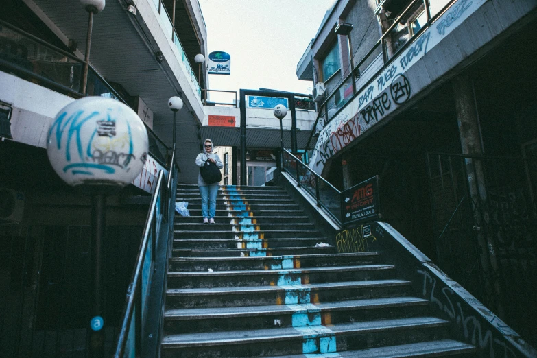 two people walking up the stairs to the top of a building