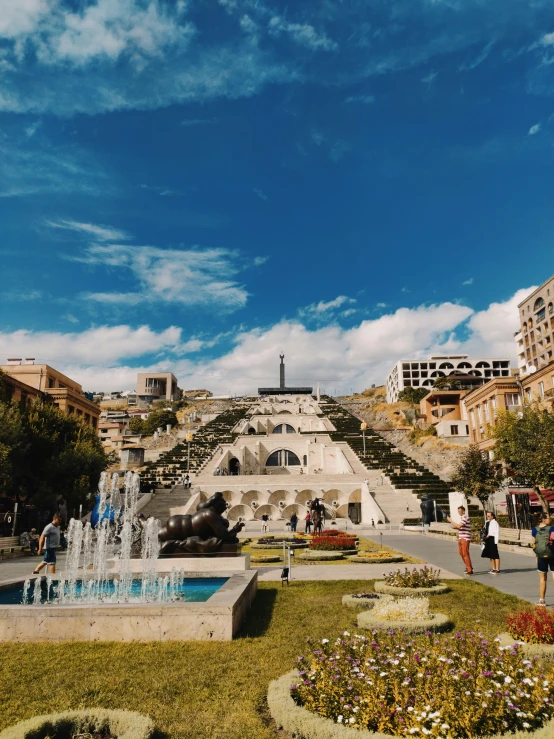 people are standing in the front of an old stone fountain