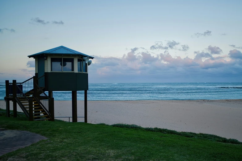 a small lifeguard tower on the side of a beach