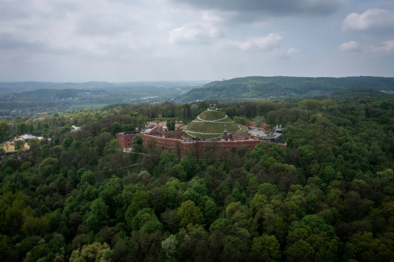 a very long building sitting on top of a lush green hillside