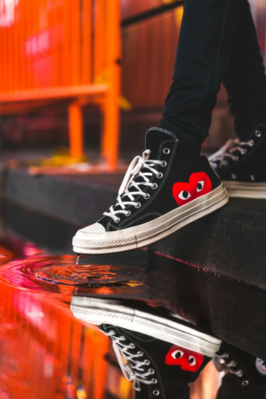 a pair of converse shoes are decorated with eyes