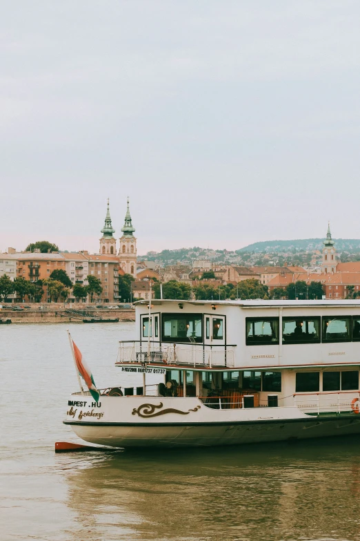 a ferry traveling along the water near buildings