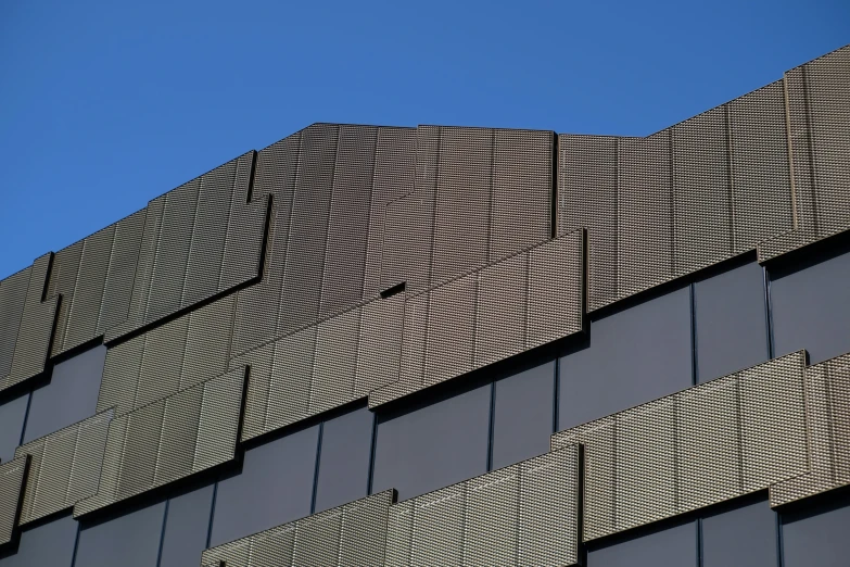 the side of a building with windows and a clock on the top