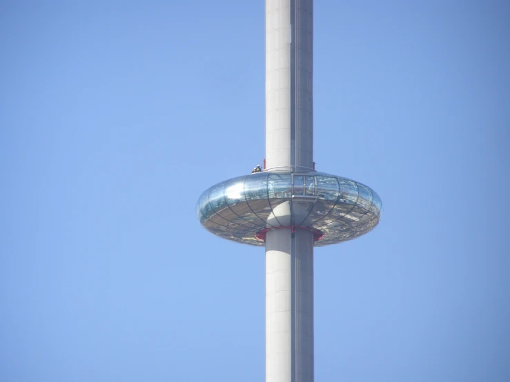 the tower has a silver base with a glass plated structure