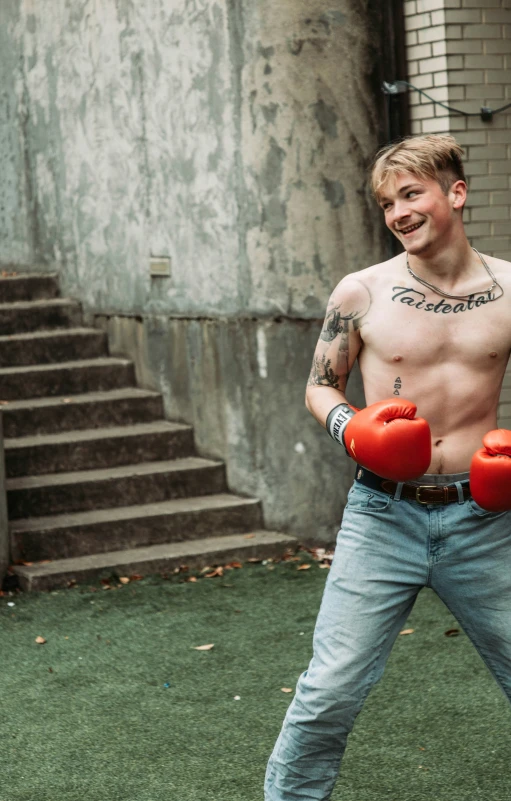 the man is preparing to punch some boxing gloves