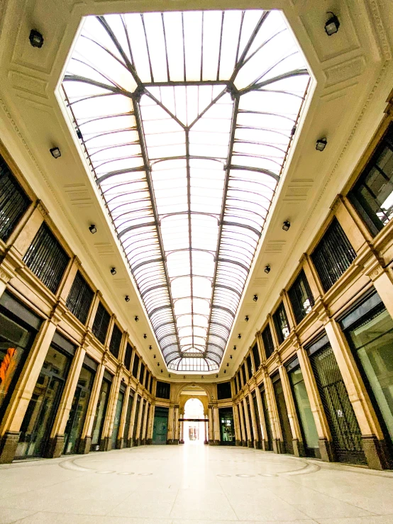 an empty atrium with large windows and a skylight