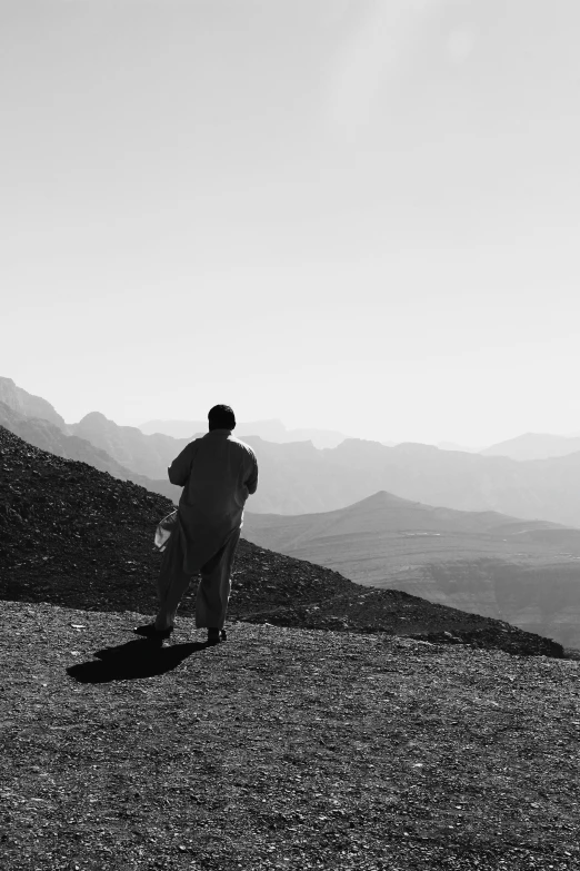 a man standing on top of a dirt hill