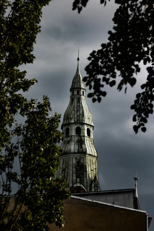 a clock tower with trees surrounding it and sky in the background