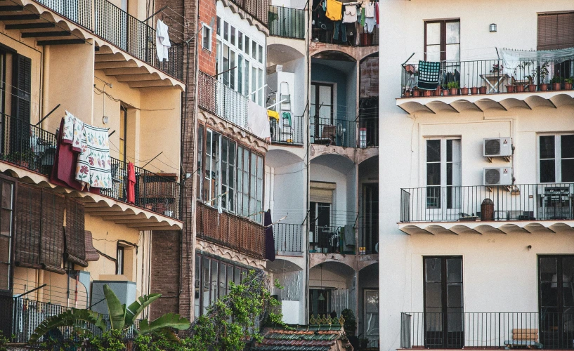 a multilevle building with balconies and plants in the balcony