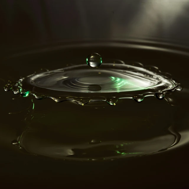 a water drop that has some green lights on it