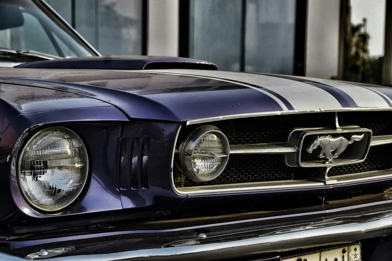 a mustang parked on the side of a building