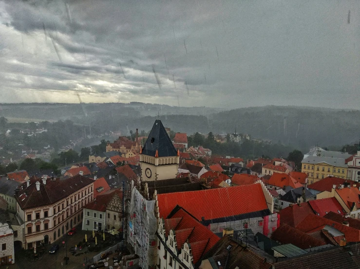 a town below a large cloudy sky with clouds