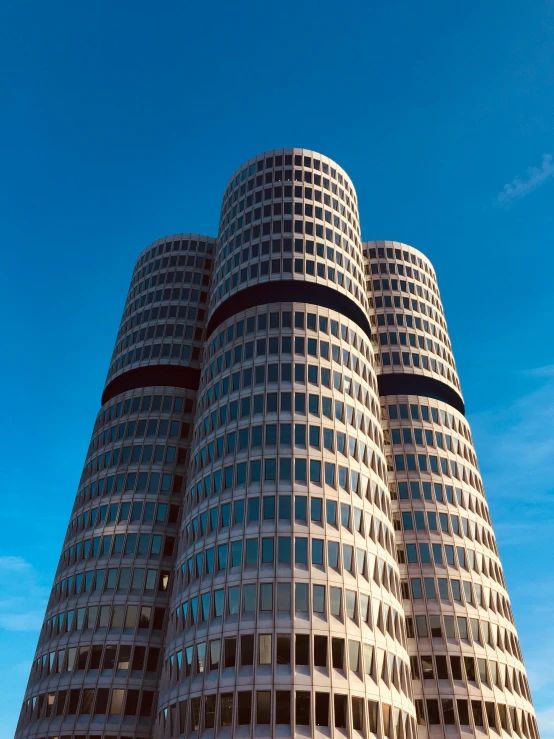 a very tall building is towering up into the blue sky