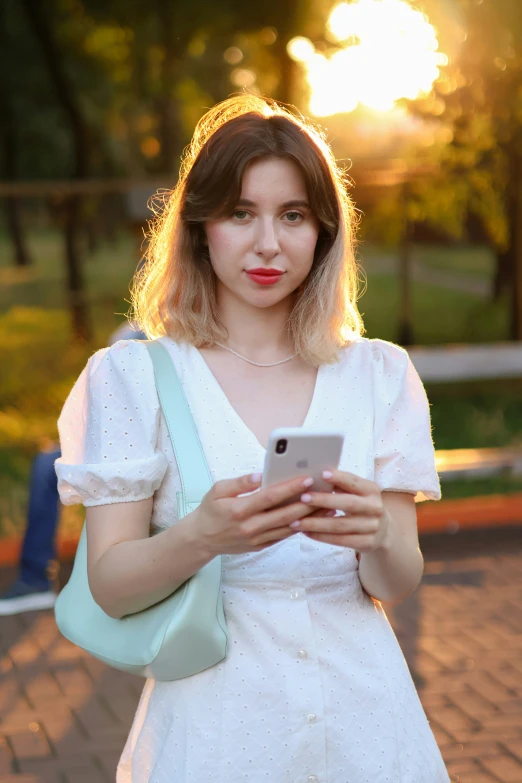 a girl is on her phone on a road