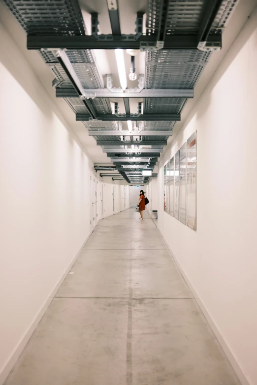 a hallway in an office building with a person standing on the other side