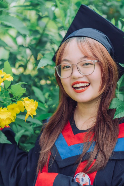a girl dressed up in graduation clothes and glasses