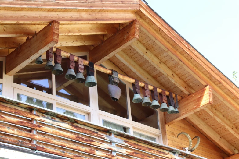 several bells hanging in between two windows