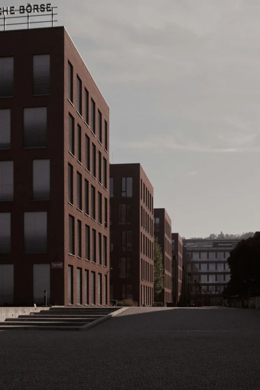 several brick building on a gray sky day