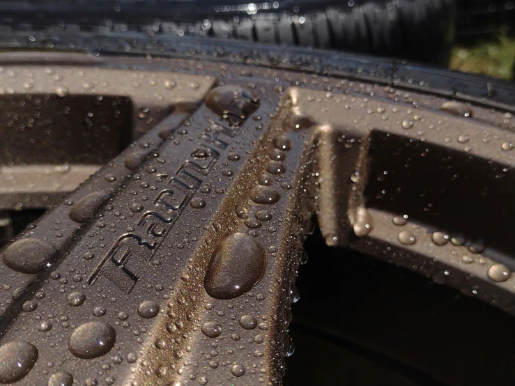 drops of water on the tire and rim of a vehicle