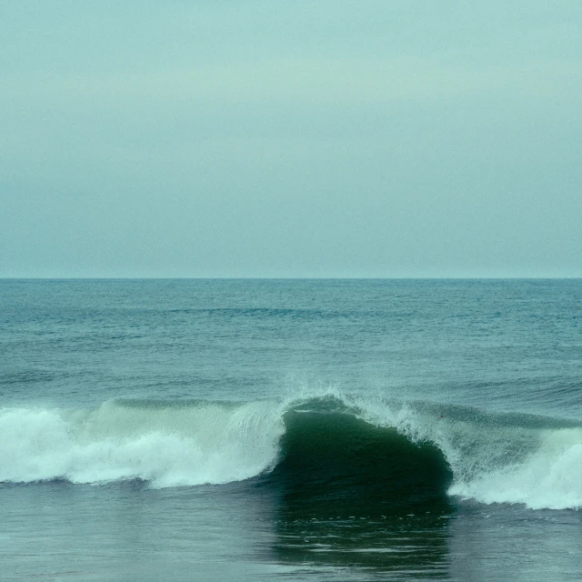 a person surfing a wave in the ocean