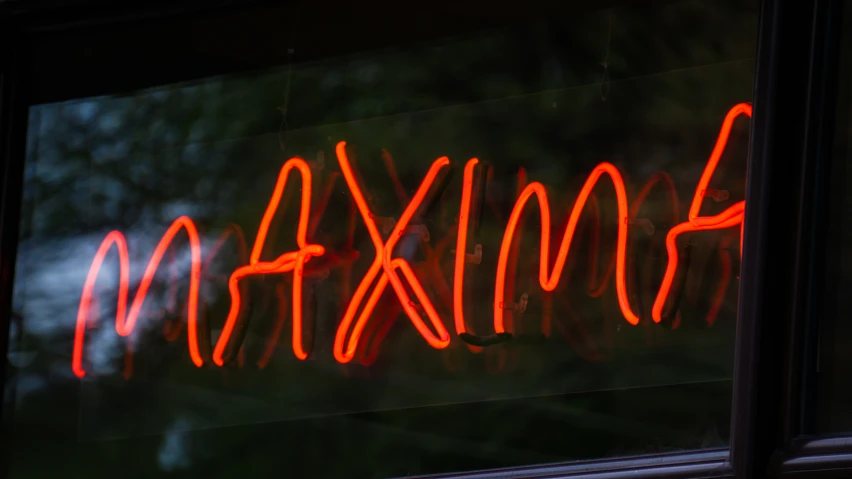 a neon sign that reads maxia written in red