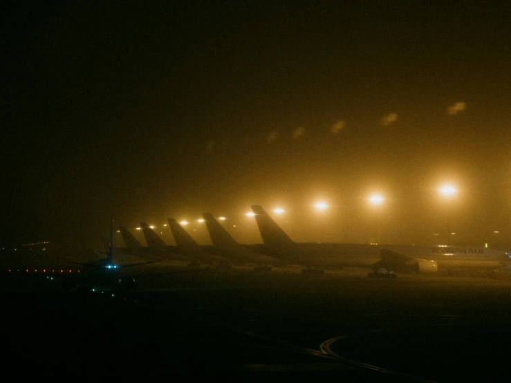 an airport runway at night with airplane lights