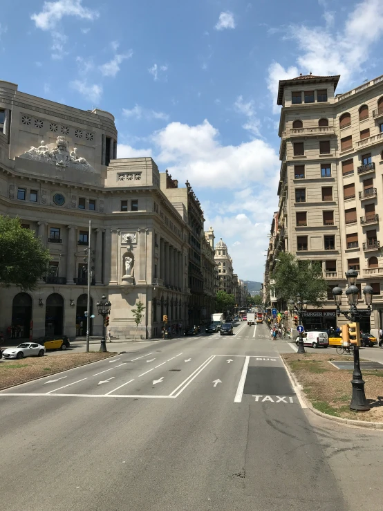 the empty street of a city, lined with buildings