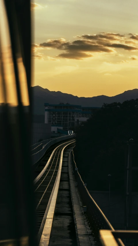 the silhouette of a train going by in the evening