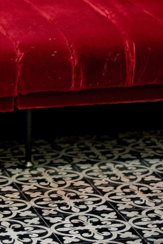 red velvet couch set with decorative pattern on the floor