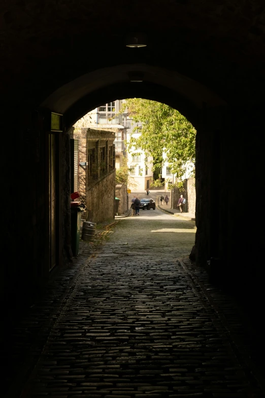 a dark alley leading into an old building