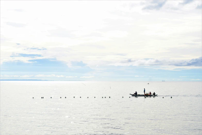 a small boat is out in the open water