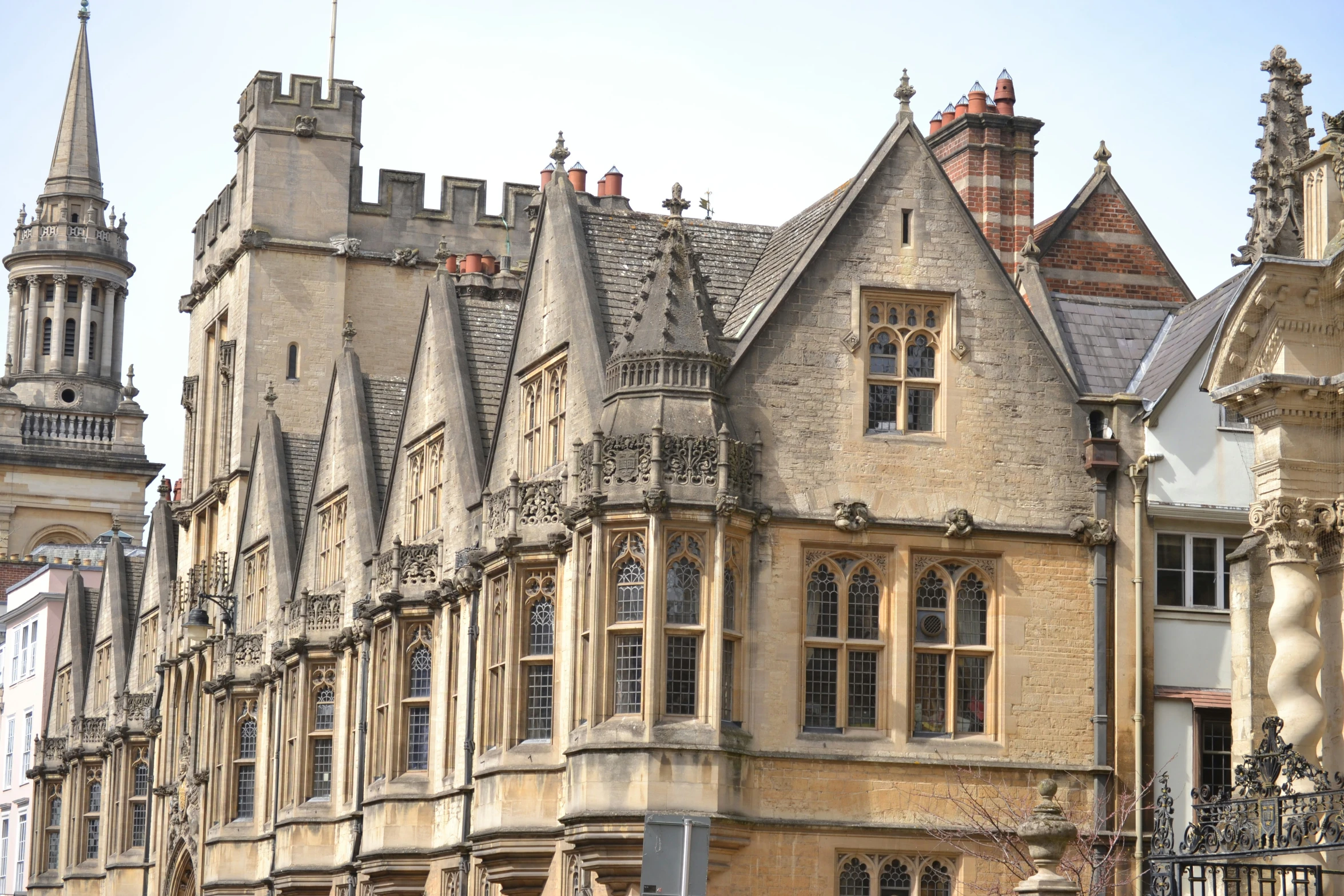 old stone building surrounded by tall trees and buildings