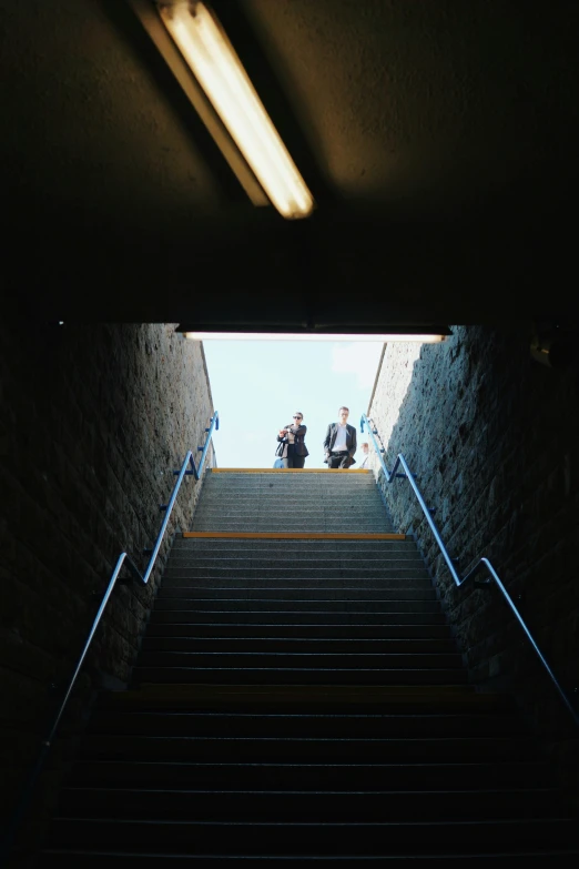 two people walking down stairs toward the sky