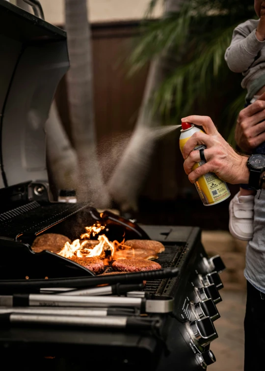 man sprinkling sauce on a piece of food