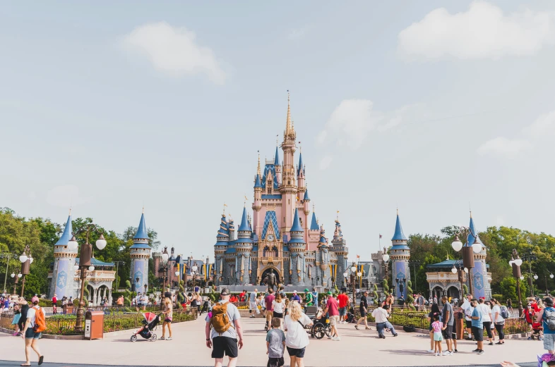 many people are outside the castle in the day time