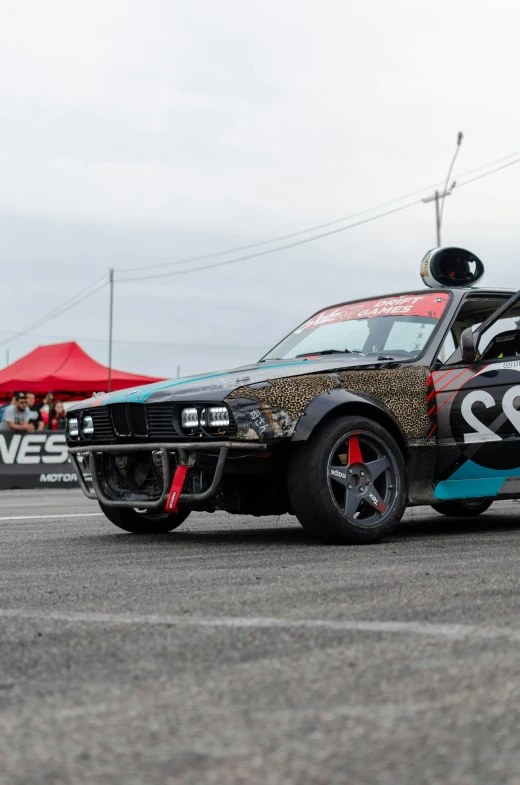 a car with colorful numbers on it drives down the street