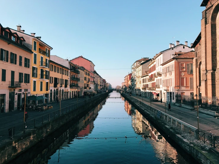 narrow canal with various colored buildings along both sides