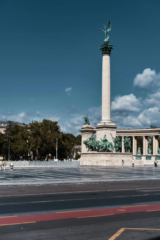 there are many people walking in front of the monument