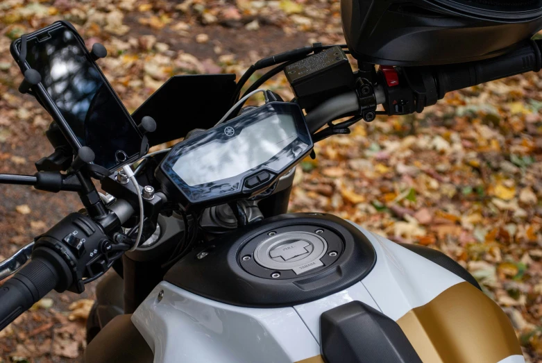 there is a cell phone on the front of a motorcycle