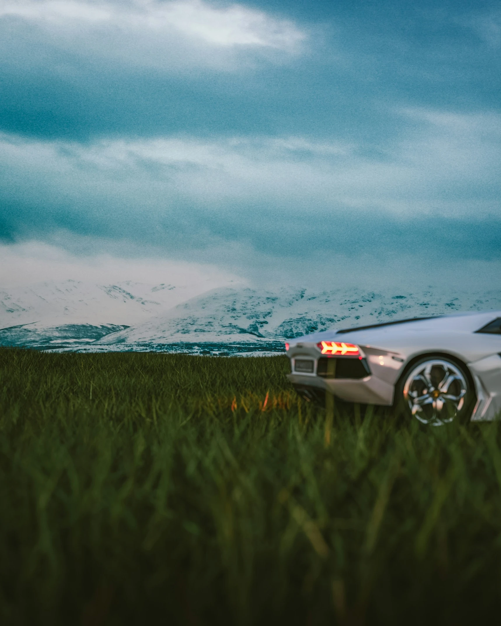 a car parked in a field next to a mountain