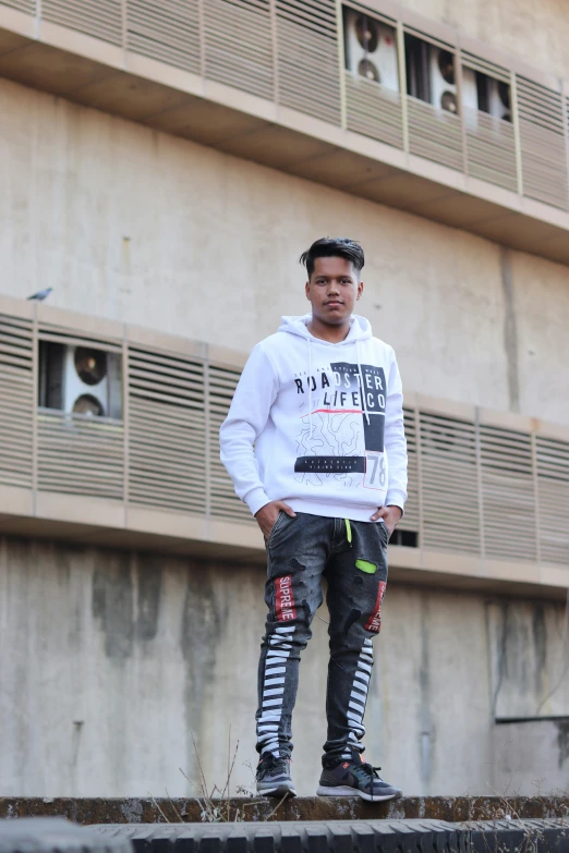 a man on a skateboard standing in front of a building