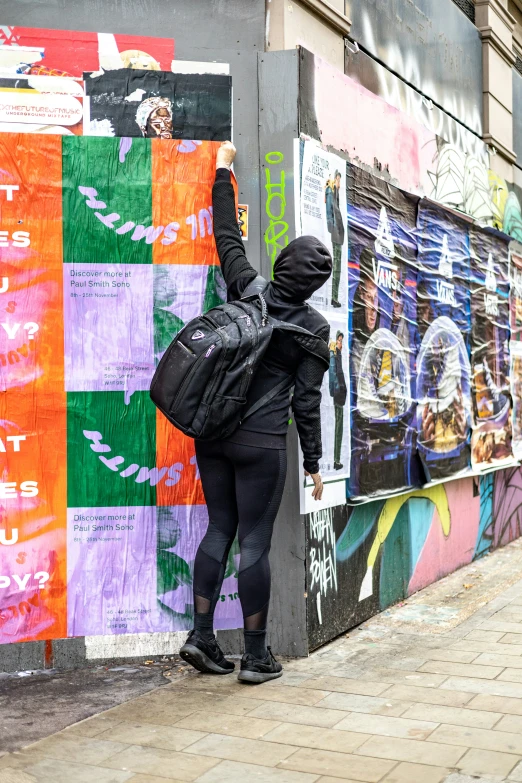 woman leaning up against a wall and scratching it