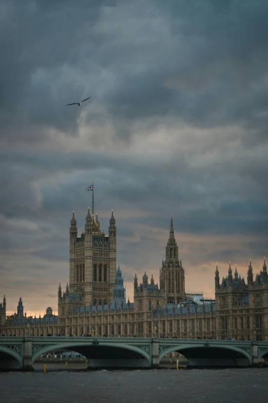 big ben with an aeroplane flying over it on top of the tower