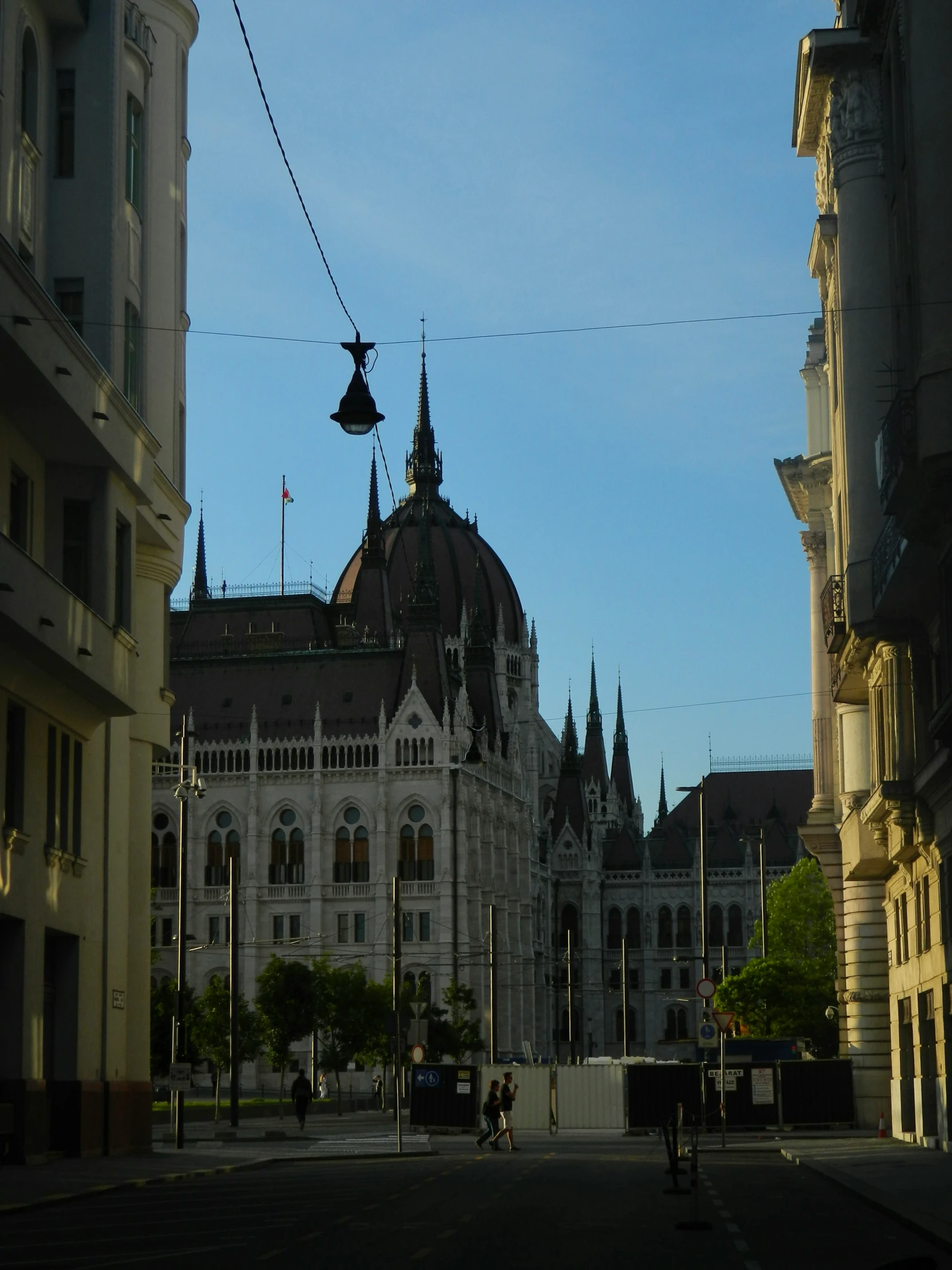 a city square with old buildings and spires