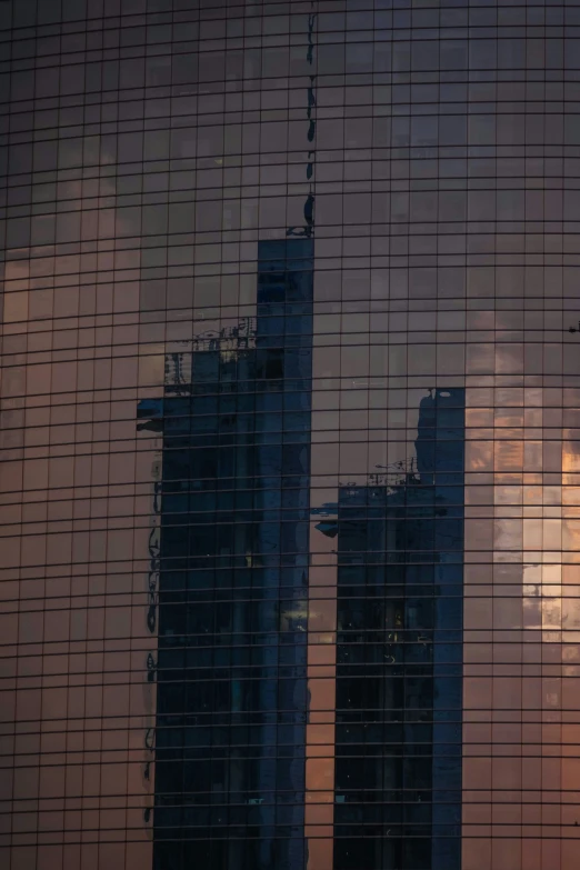 the reflection of some very tall buildings in the glass