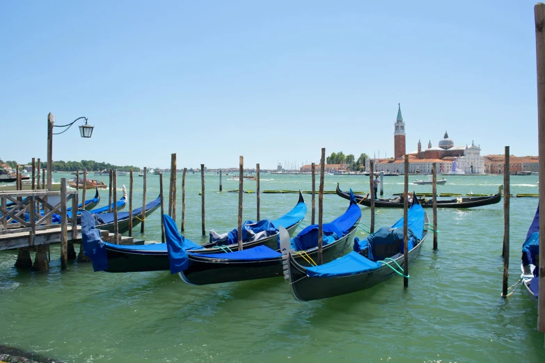 four boats docked on a body of water