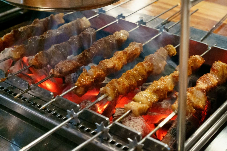 several skewers of food sitting on top of a grill