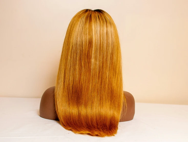 a wig sitting on top of a table near a white wall