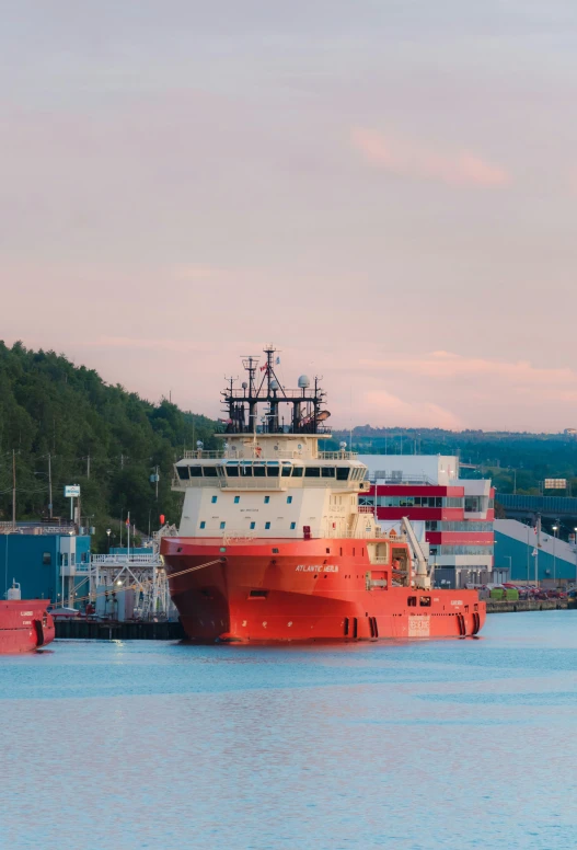 a large boat docked next to another vessel