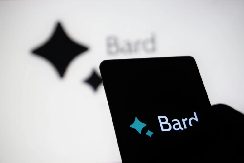 the bard logo is reflected in the back of a cell phone